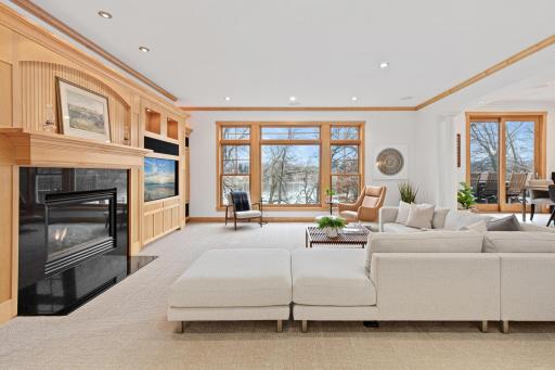 As you step into the gracious foyer of this stunning home you are greeted by equally stunning panoramic views of the lake from the living room, dining room, and the kitchen.