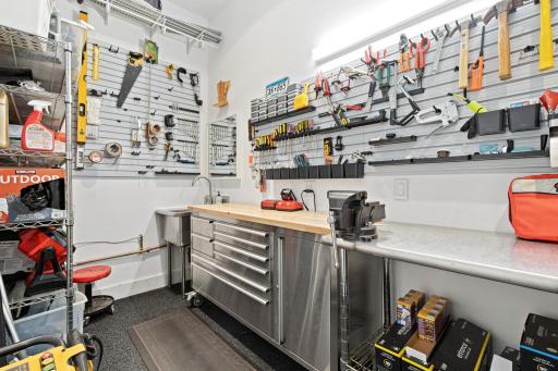 This fabulous work room is located inside of the heated garage and has an extensive slat wall storage system and a sink with hot and cold water.