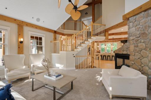 Motorized blinds and unique ceiling fans add sophistication, while the double-sided gas fireplace offers warmth and charm.