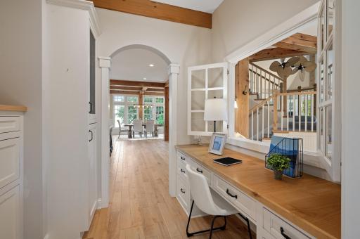 Tucked away near the foyer, the open office space features built-in cabinetry and a desk, making it a functional yet stylish workspace with plenty of storage.