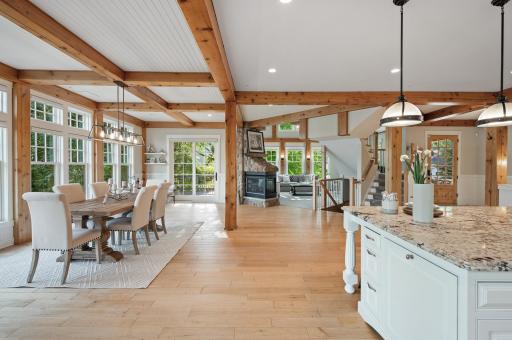 Enjoy beautiful lake views from the dining table, complete with cozy seating by a double-sided gas fireplace and direct access to two separate decks.