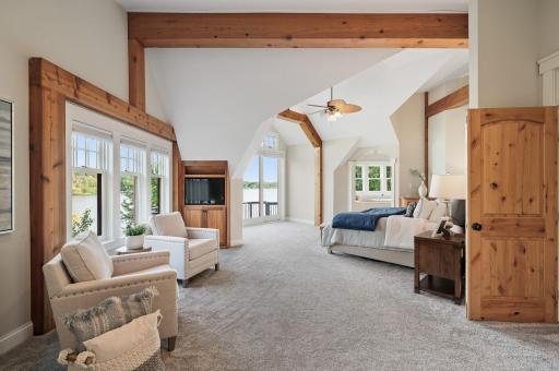 Step into your luxurious primary suite on the upper level featuring a 13-foot vaulted ceiling, and motorized blinds.