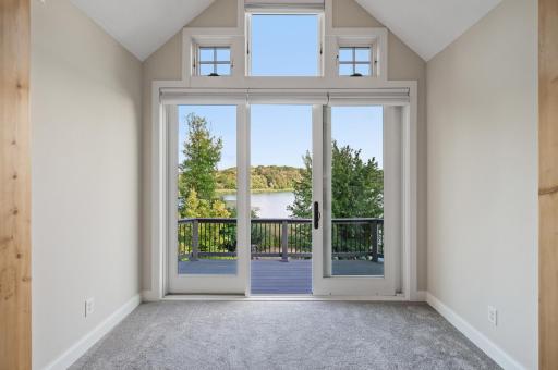 A serene seating area with breathtaking lake views, and access to a private balcony.