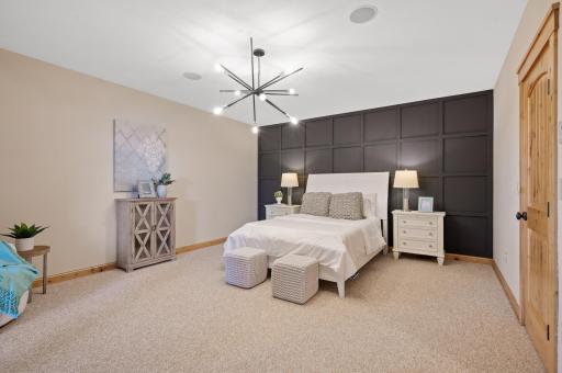 The lower level includes an additional bedroom with a gridded accent wall and private access to a secluded patio.