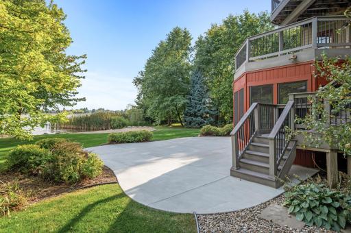 The lush, flat yard leads to a recently enhanced sandy beach with 15 tons of new sand, perfect for enjoying lakeside life.