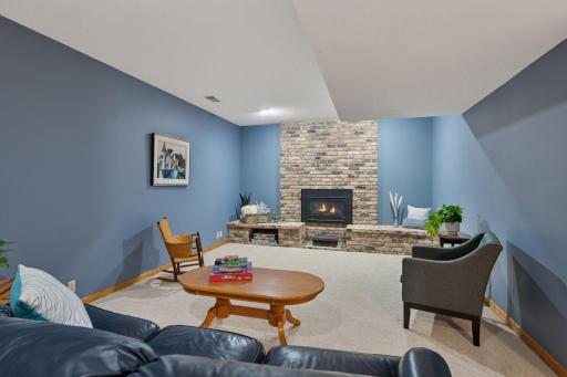 Stunning brick surrounds your lower-level gas fireplace.