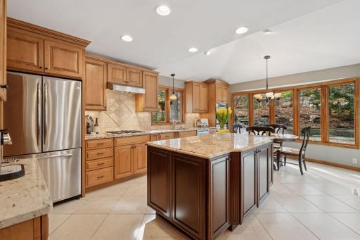 A chef's dream kitchen - modern appliances, ample counter space, and a functional eat-in layout.
