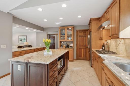 Gather and entertain in this beautifully updated kitchen with an oversized island, walk-in pantry, and breakfast bar.