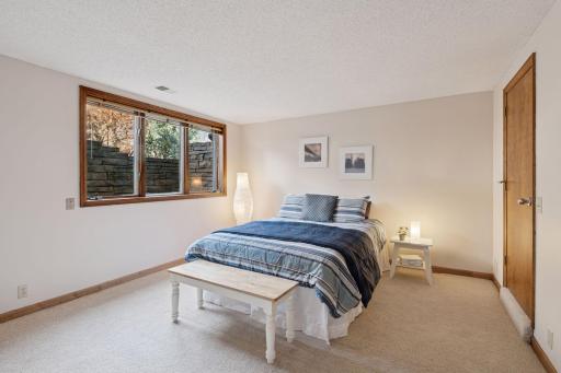 Spacious and inviting lower-level bedroom with large egress windows for natural light and safety.