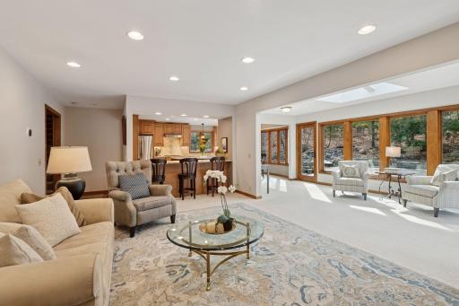 The seamless flow between the living room, sunroom, and eat-in kitchen with a breakfast bar makes this open-concept space perfect for entertaining and everyday living.