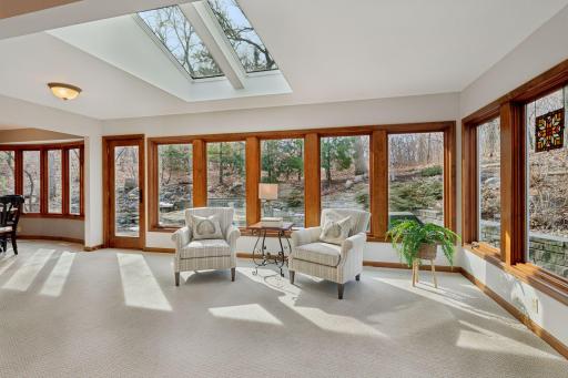 This stunning sunroom, once a porch, now boasts Marvin windows and skylights creating a bright and serene space to enjoy the outdoors year-round.