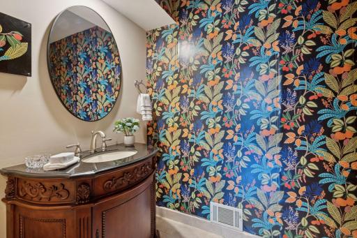 The updated main floor bath has an on-trend peel & stick wallpaper accent wall.