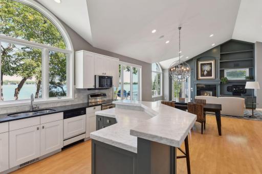 Two-tiered center island provides additional cabinet space for storage and counter space for meal prep or entertaining