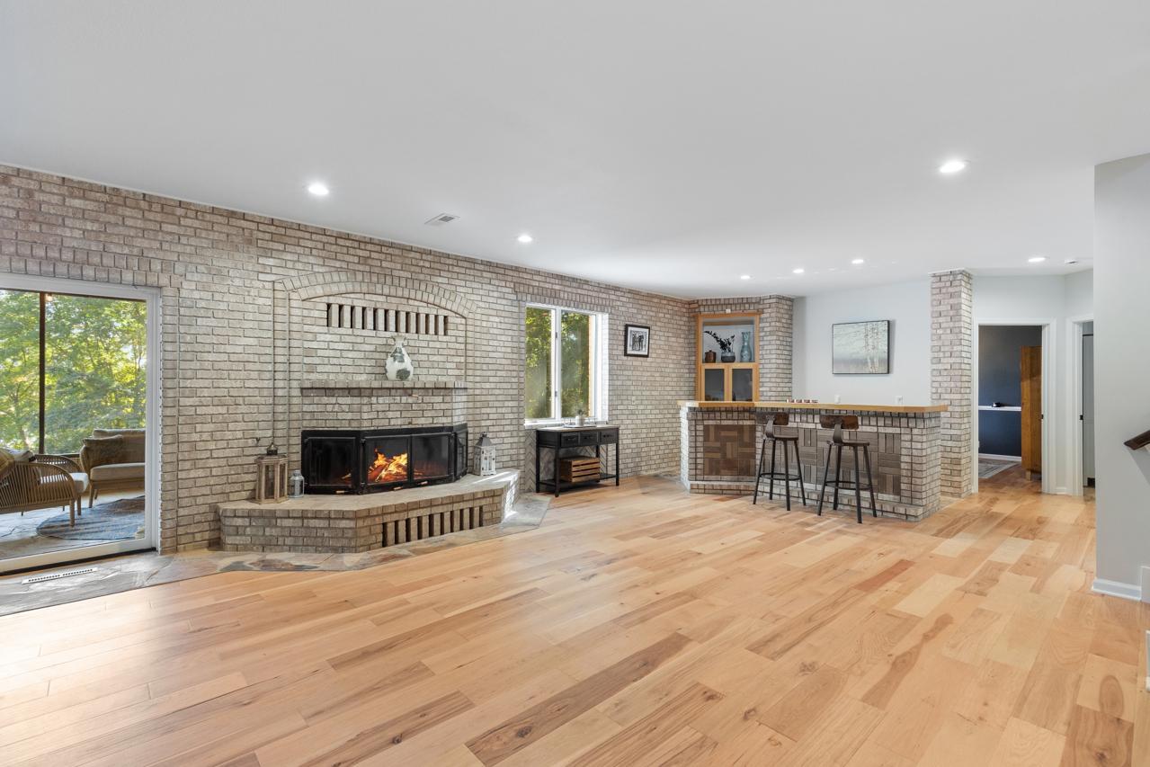 Lower Level Family Room with Wood Burning Fireplace and Bar