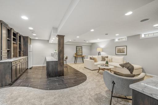 Spacious Lower Level Family Room and Bar. A great space to watch the big game, entertain guests, or enjoy movie night.