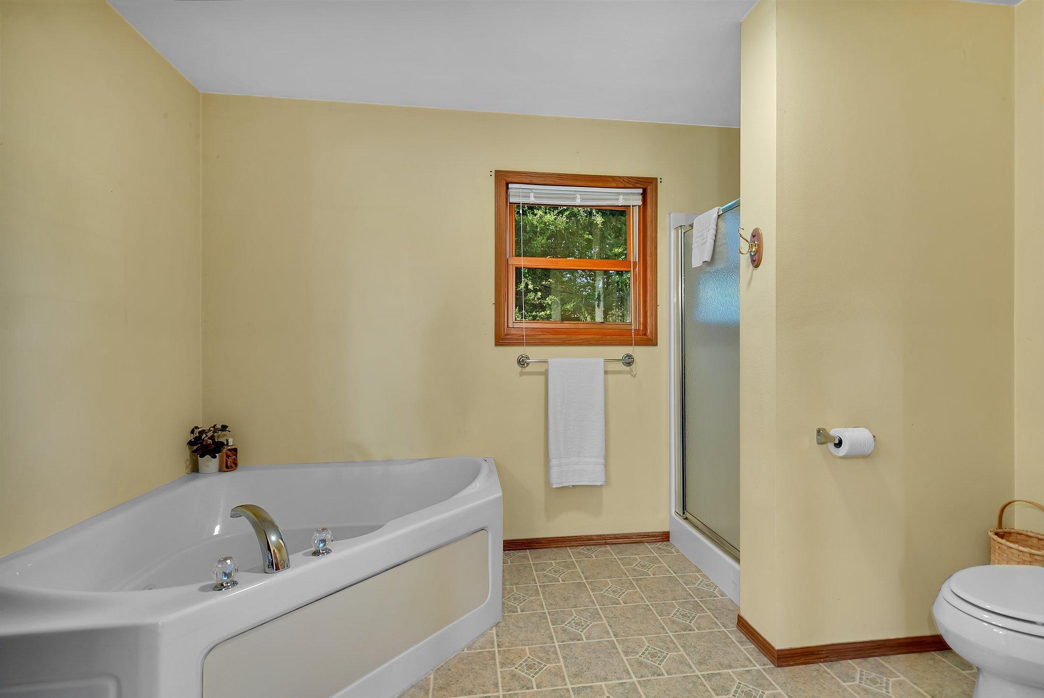 Relax in the Jacuzzi tub in the Primary Bathroom
