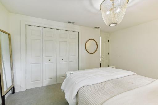 Maximize your storage in this cozy bedroom, featuring a double door closet that combines style and functionality for all your belongings.