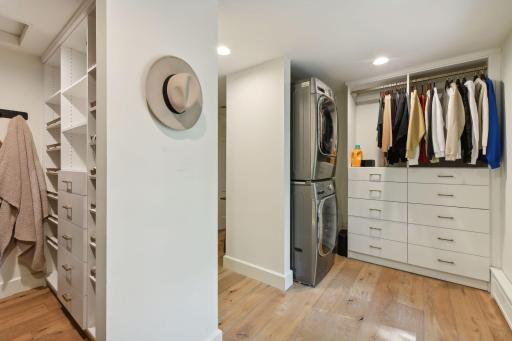 Indulge in the luxury of a stunning primary suite dressing room, featuring custom built-ins and your own washer and dryer for ultimate convenience and style.