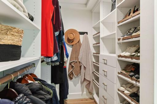 Step into the California-style dressing room in the primary suite, offering expansive space and sleek organization for all your wardrobe needs.