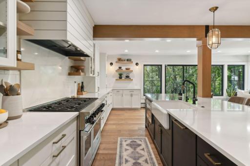 Experience culinary bliss with an elegant farm sink paired with a commercial-grade gas stove, perfect for gourmet cooking and entertaining.