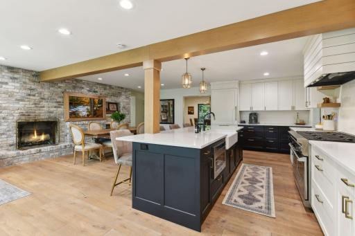 Create lasting memories in this open-concept kitchen, featuring a cozy fireplace that adds warmth and charm to your culinary experiences.