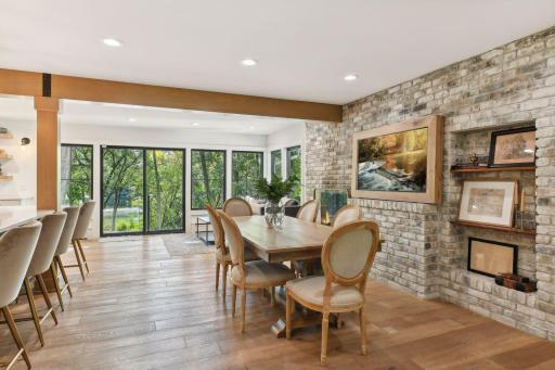 Enjoy the perfect blend of modern elegance and rustic charm in this dining room, featuring original stonework.