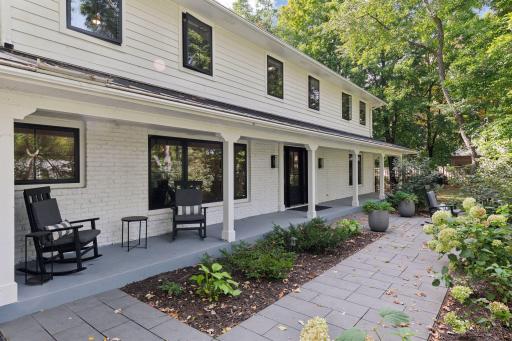 The Bluestone Walkway and spectacular porch are surrounded by artfully designed landscaping.