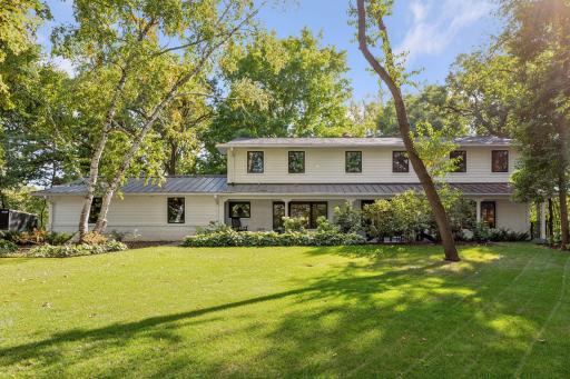 Professionally designed landscaping in the front yard, creates a stunning first impression.
