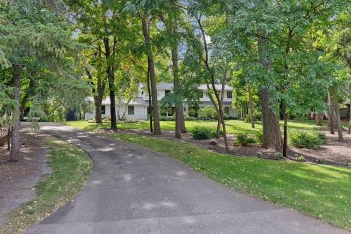 Follow the charming winding driveway that leads you home, offering a perfect blend of privacy and scenic beauty.