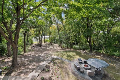 Follow the inviting stairs leading down to your outdoor firepit, where cozy evenings and warm gatherings await under the stars.