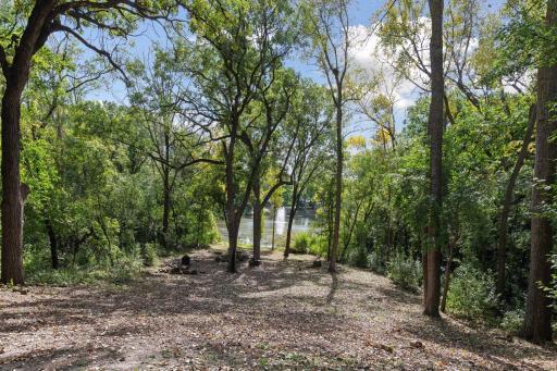 Enjoy a picturesque walking path with gentle elevation leading down to the tranquil water feature, offering a serene escape just steps from your home.