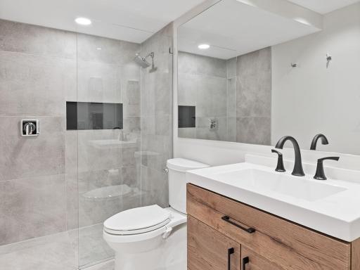 This stunning guest bathroom boasts a spa-like ambiance with sleek fixtures and luxurious finishes.