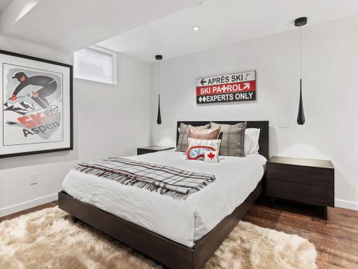 This modern guest suite combines sleek design with warm finishes, creating a cozy retreat where guests can unwind in style.