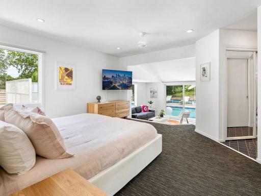 Stunning primary suite with sunken sitting area overlooking the pool.