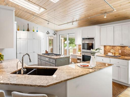 Spacious light-filled kitchen with custom cabinetry and premium appliances.