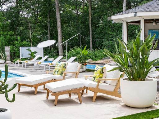 This stunning MCM inspired backyard captures the essence of Palm Springs with its vibrant landscaping and shimmering pool, creating a chic oasis for relaxation and entertaining.