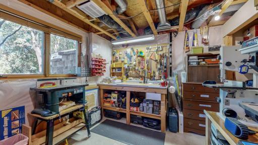 Workshop is located in the lower level with egress window and framed closet for possible 5th bedroom or office space.