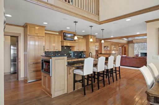 The gourmet kitchen is a chefâs dream, boasting custom Maple cabinetry that offers both style and function. The rich wood tones add warmth to the space, while the ample storage and soft-close features ensure practicality.