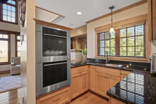 A scullery with double ovens is perfect for additional prep space, a coffee bar, or a baking station.