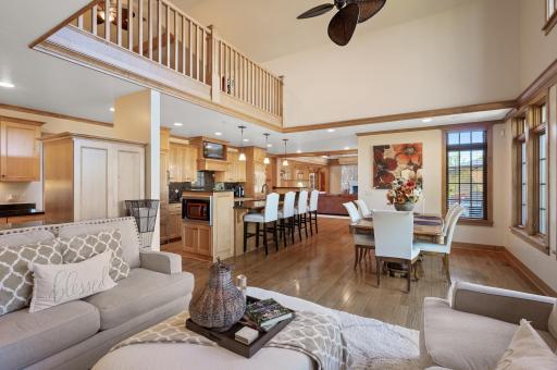 Natural light flows freely throughout, enhancing the airy, spacious feel while providing a sense of unity between living, dining, and kitchen areas.
