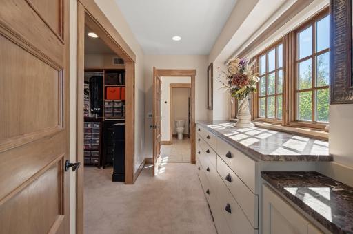 Soft lighting enhances the sophisticated atmosphere, making the dressing room not only functional but a serene space to begin or end your day in style.