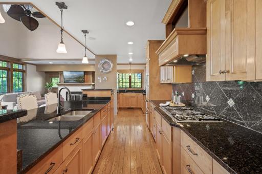 The elegant granite surfaces provide a stunning contrast to the warm wood tones. And top-of-the-line Wolf and Sub Zero appliances ensure a professional cooking experience.