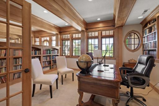This spacious private office is designed for both productivity and style, featuring custom-built bookshelves that add a touch of sophistication.