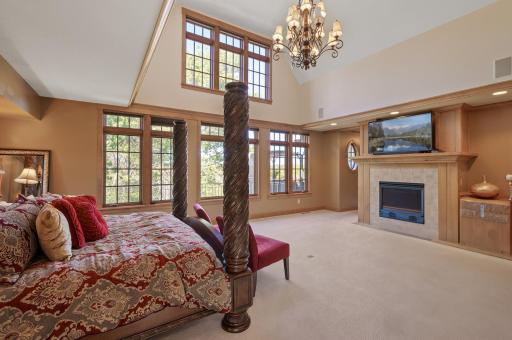 The main floor is home to the primary suite. This luxurious retreat offers vaulted ceilings and beautiful views.