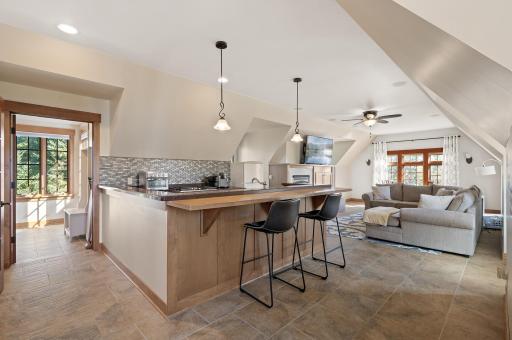 The private guest or in-law suite offers a self-contained retreat, complete with a fully equipped kitchen and a cozy living room.
