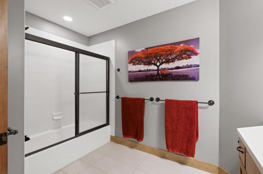 The ensuite bathroom is well appointed and offers convenience for guests or family members, making it an ideal space for relaxation.