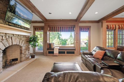 The lower level features a family room with stunning beams, a projector and screen for movie nights.