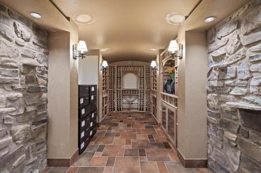 This custom wine cellar is the ultimate retreat for wine enthusiasts. The stone accent walls add a touch of rustic charm, contrasting beautifully with the polished wood tones.