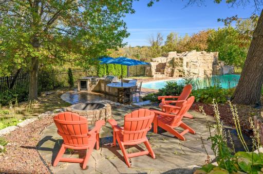 This cozy fire pit area overlooks the sparkling pool, creating a perfect blend of warmth and relaxation.