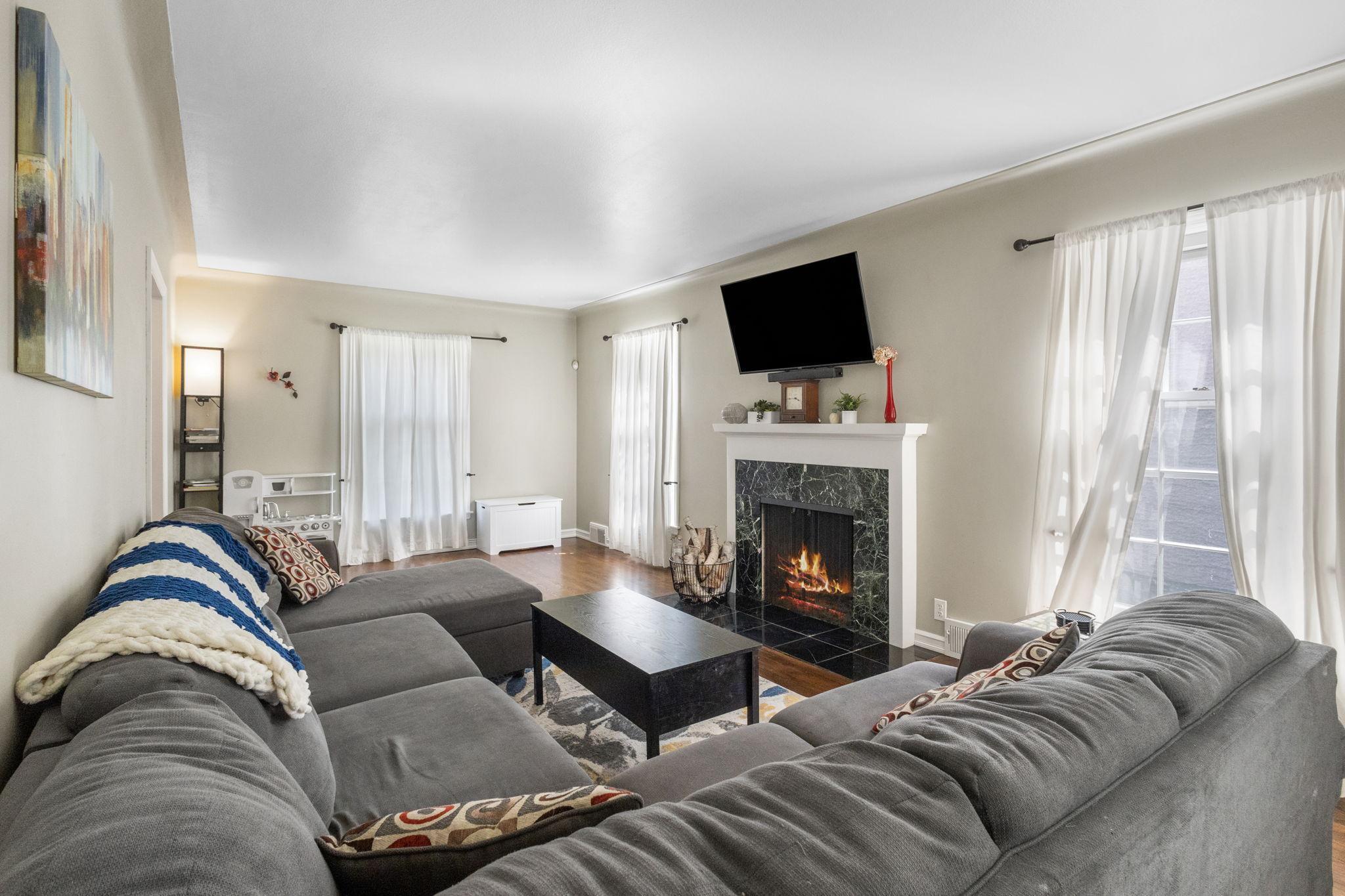 Large windows throughout flood the rooms with natural light.